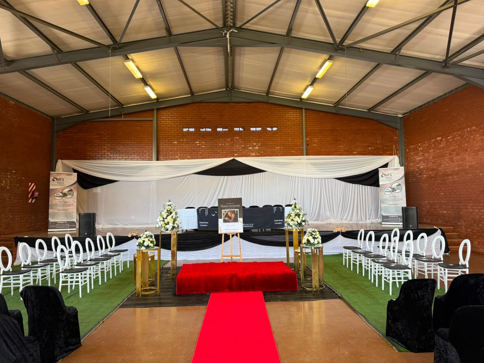 A memorial service set up by MFS, with draping, flowers and chairs